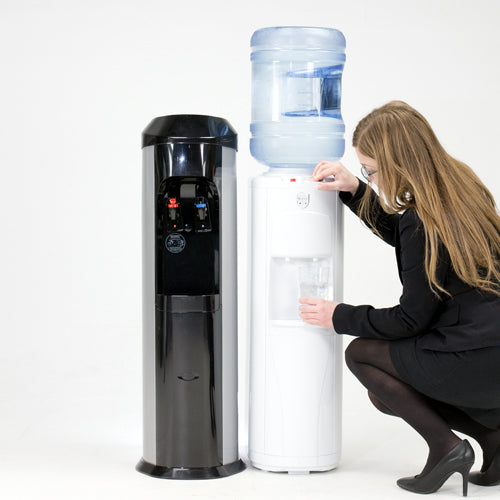 Woman bending down filling glass with water using bottle less cooler